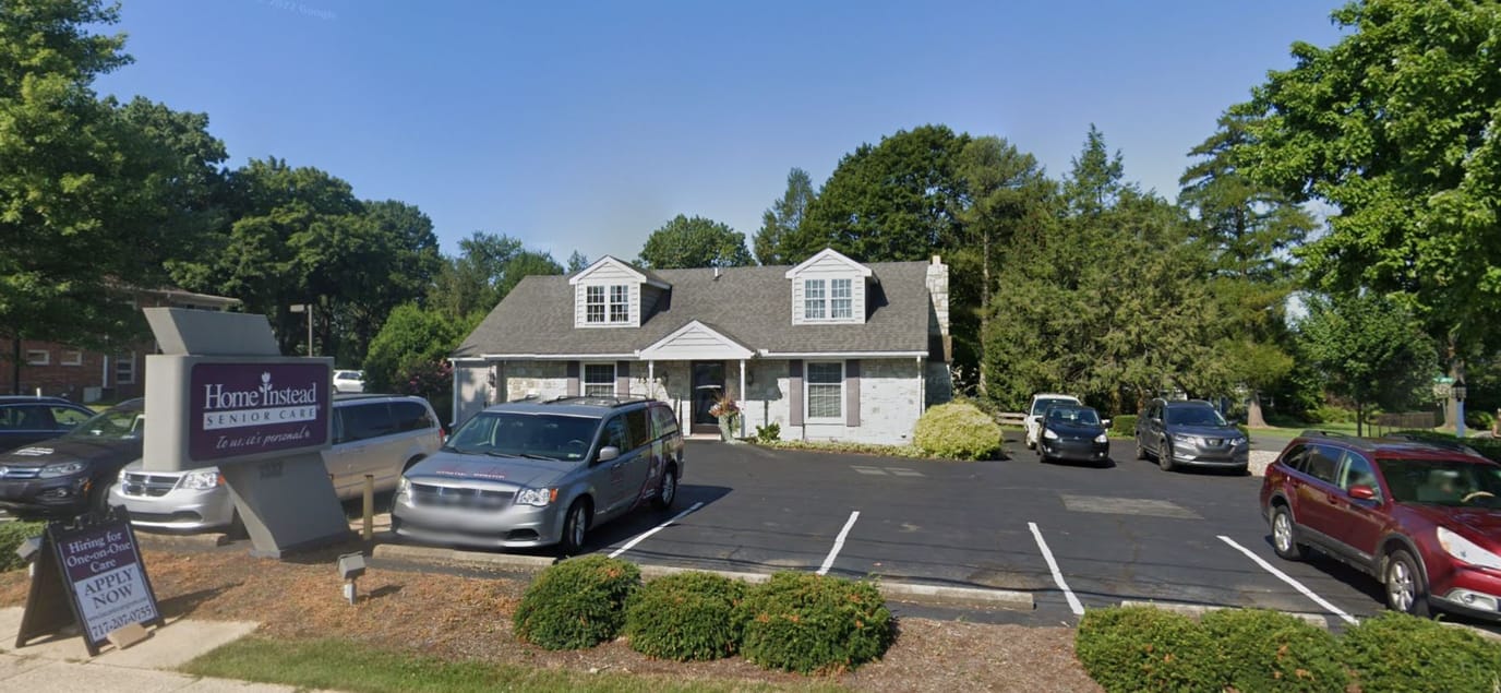 Exterior view of Home Instead facility with parking area