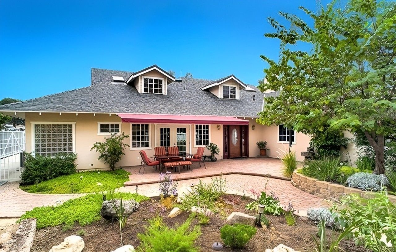 Exterior view of a senior living facility with garden