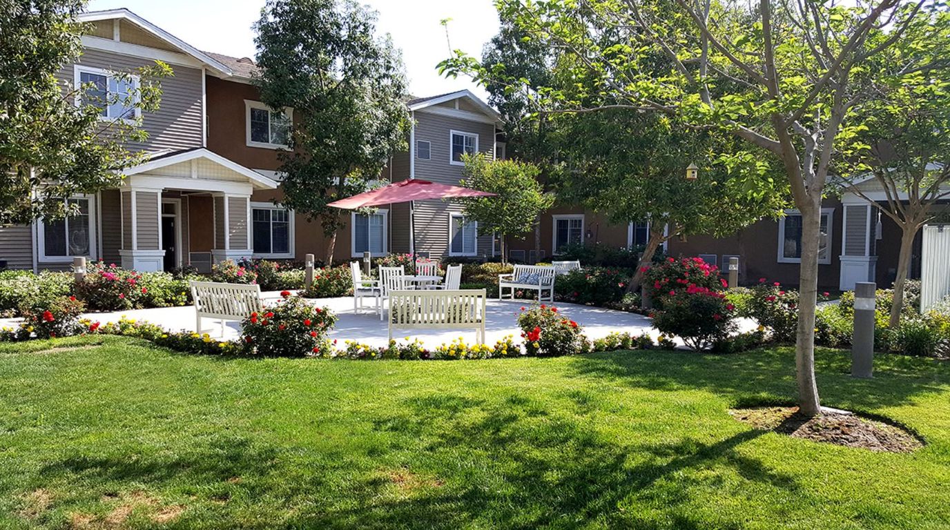 Outdoor garden area with seating and flowers