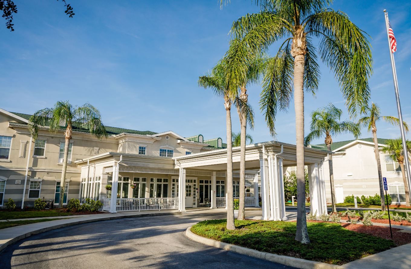 Exterior view of Sodalis Senior Living with palm trees