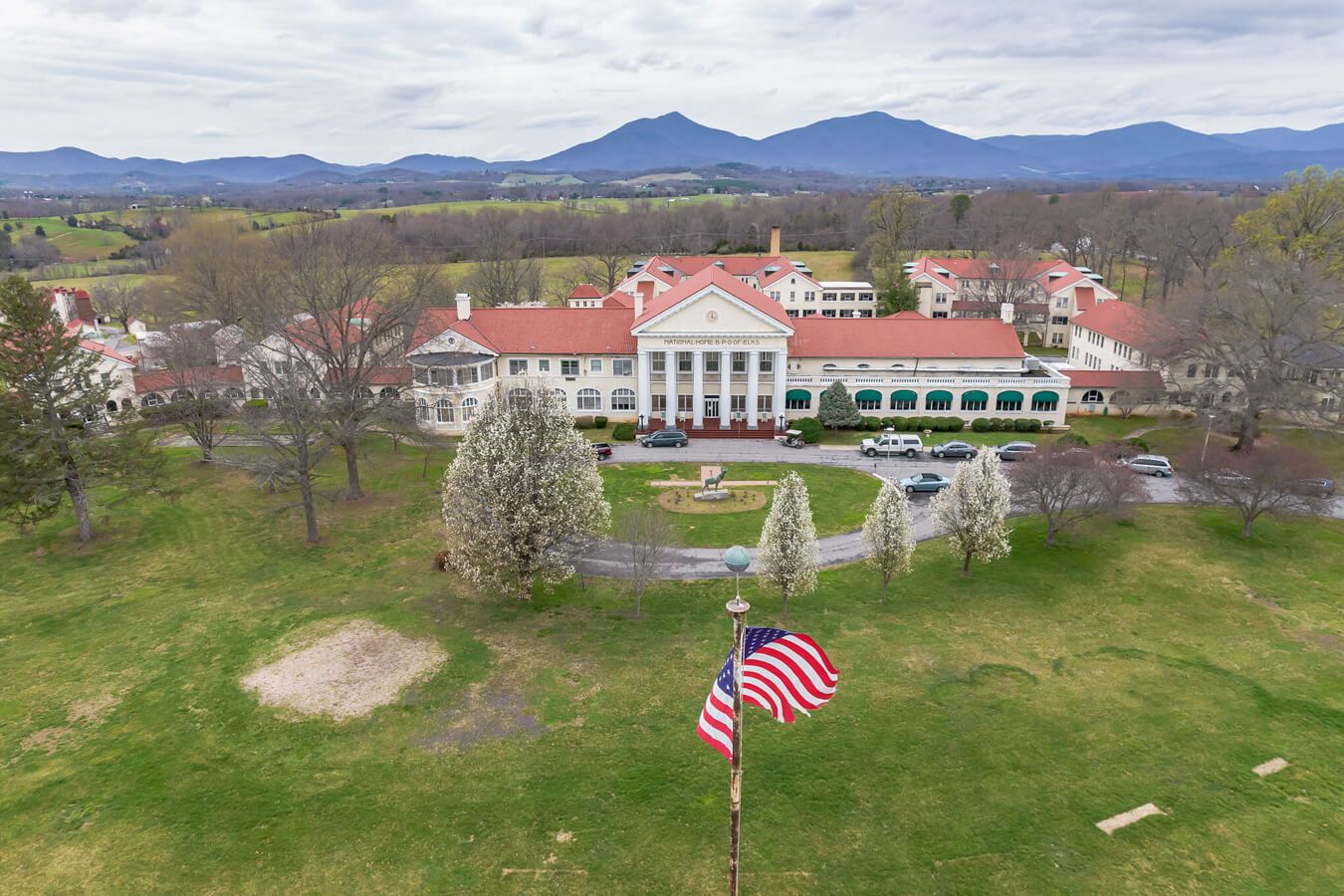 Aerial view of the facility with mountains in the background