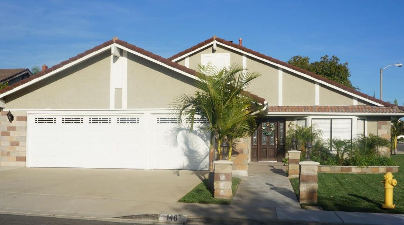 Exterior view of a single-family home with a garden