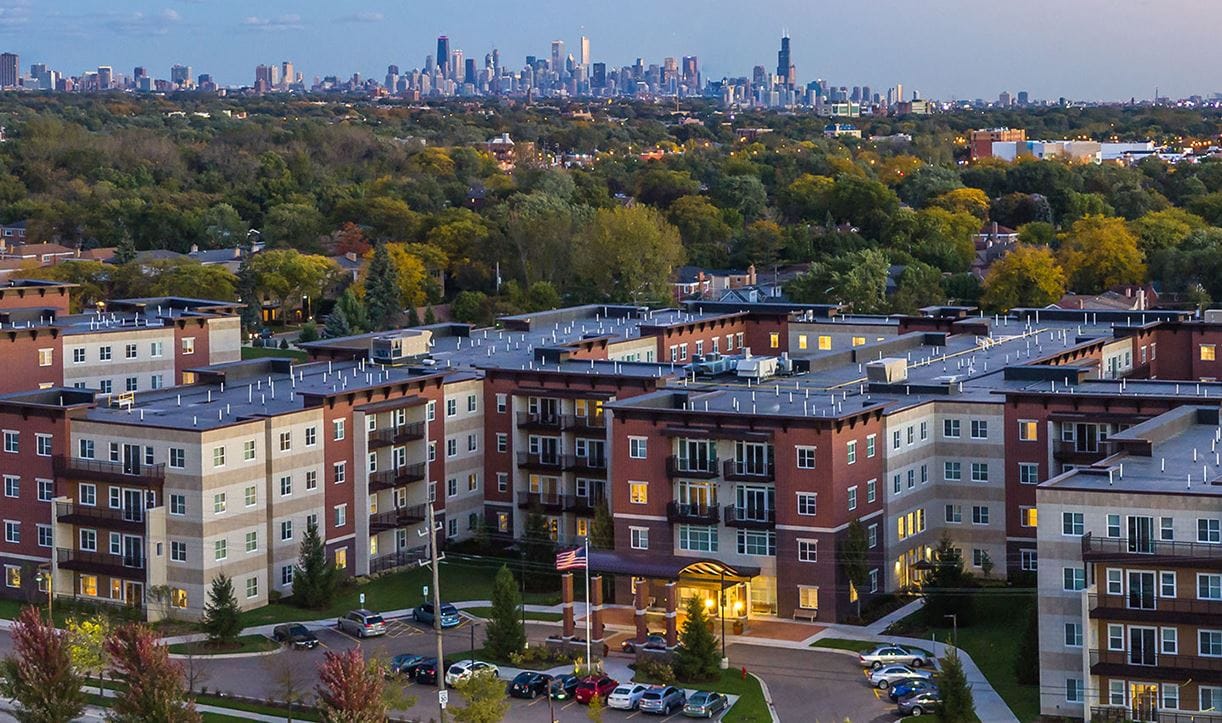 Aerial view of a nursing home facility with city skyline