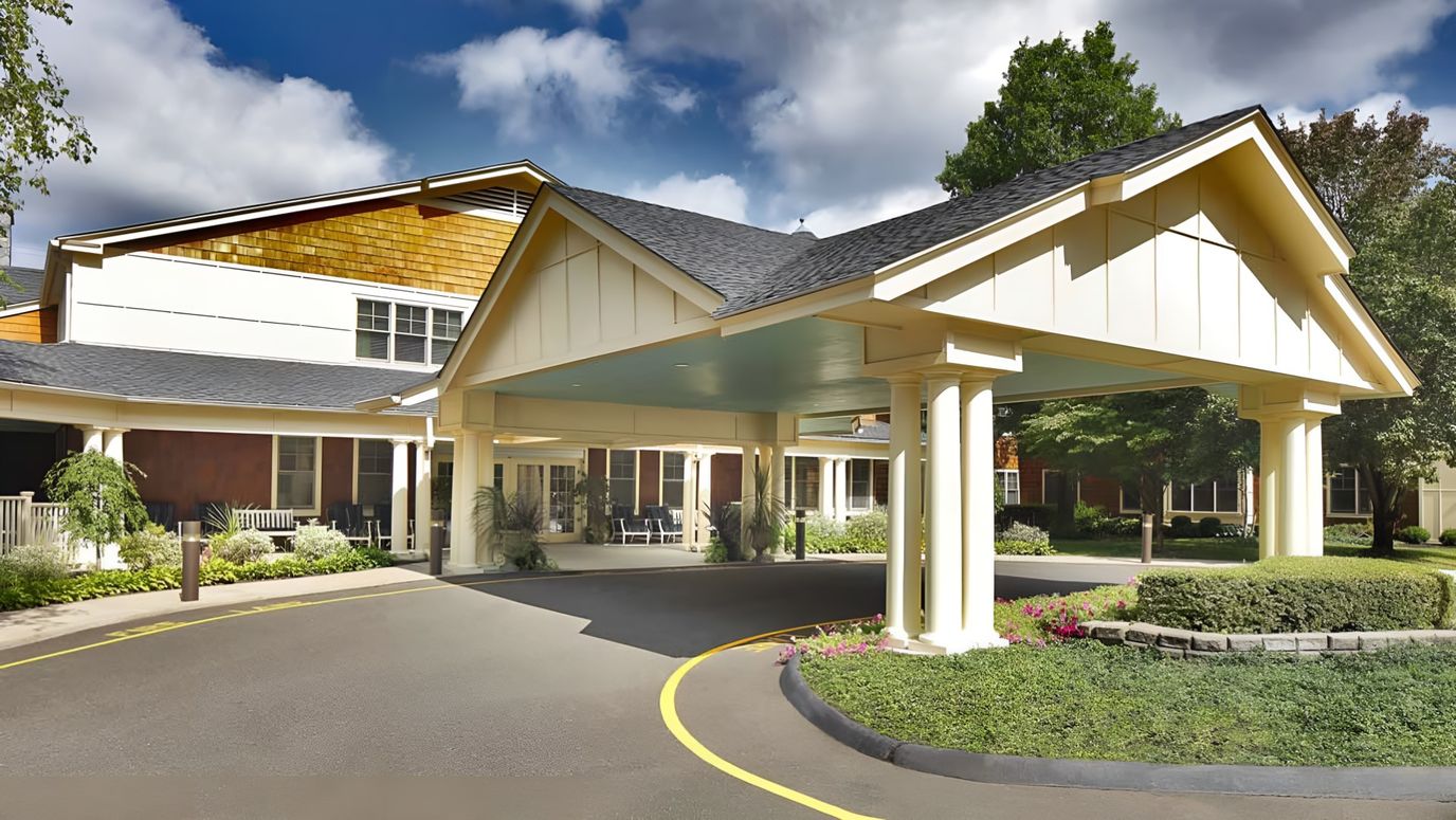 Front entrance of a senior living facility with covered drive