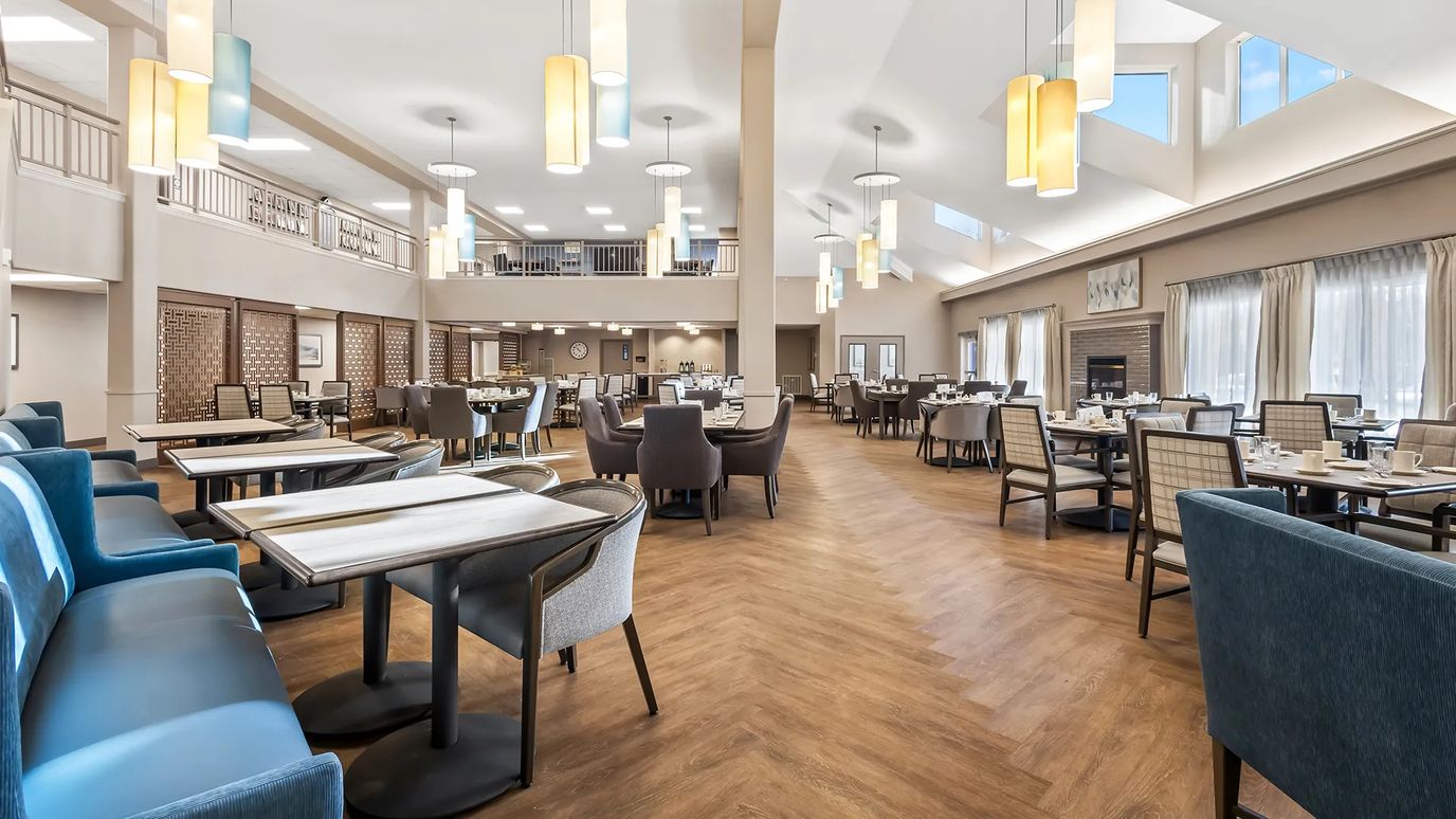 Spacious dining room with tables set for meals
