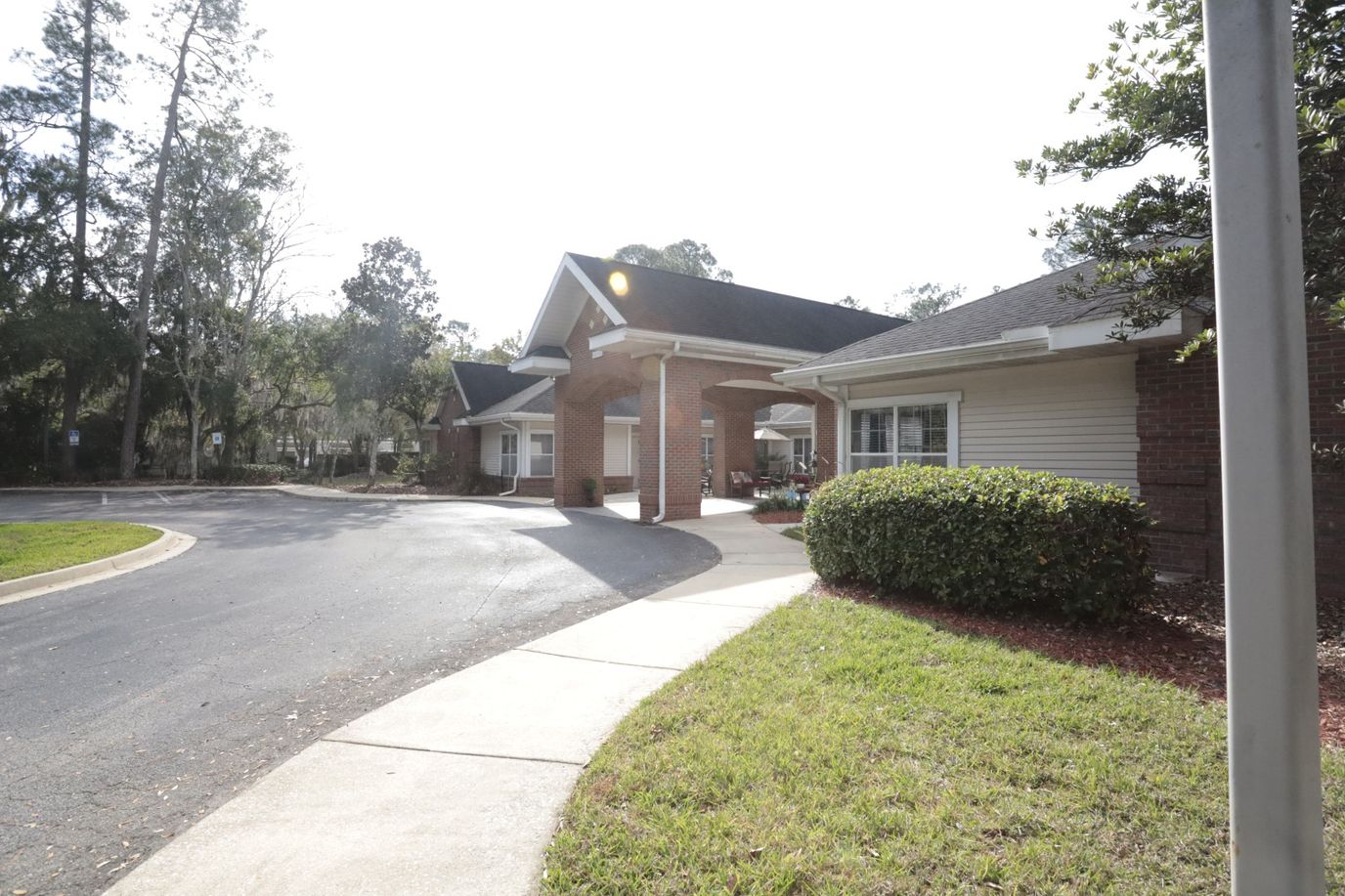 Exterior view of a senior living facility with landscaping