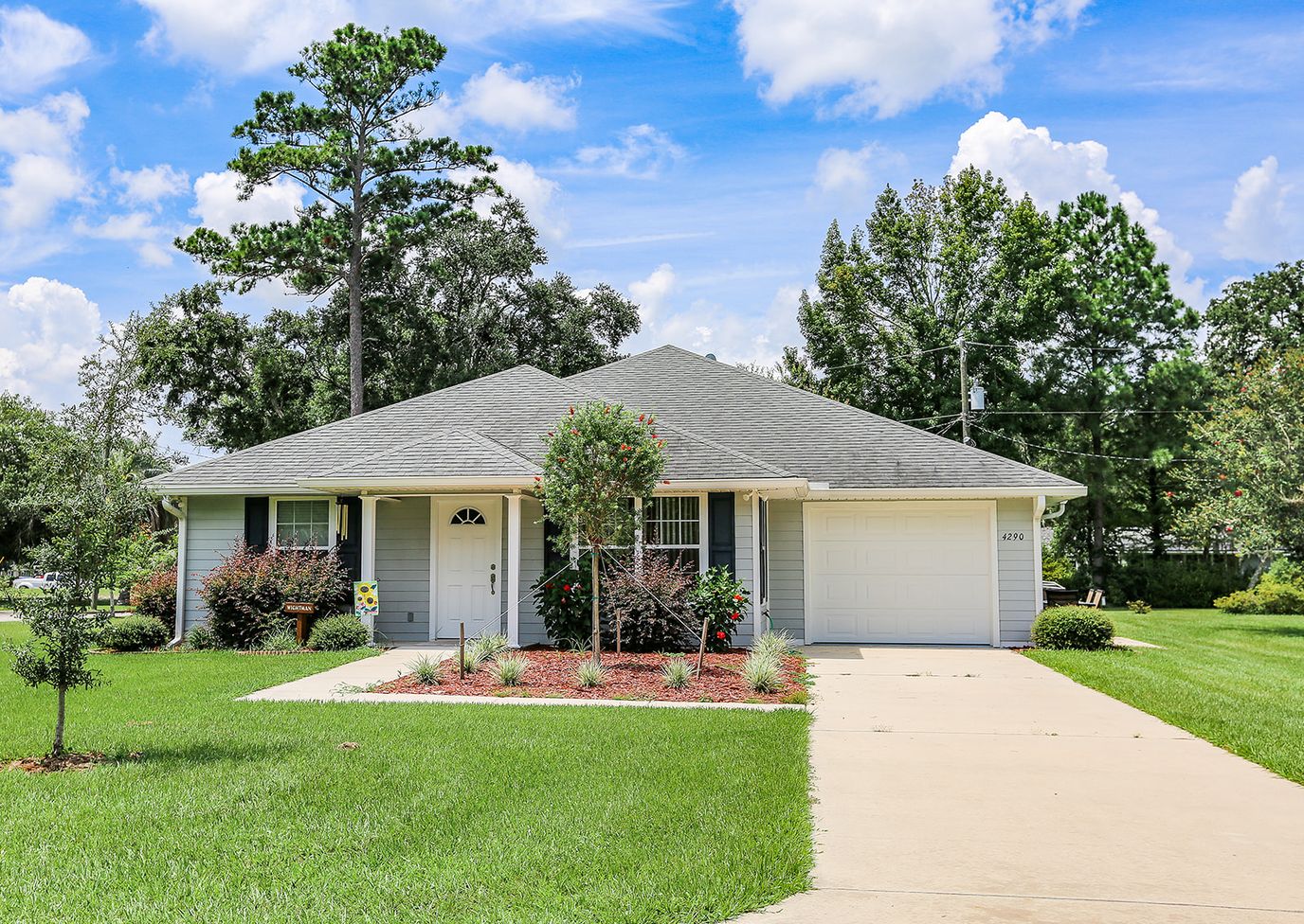 Exterior view of a residential building with well-maintained landscaping