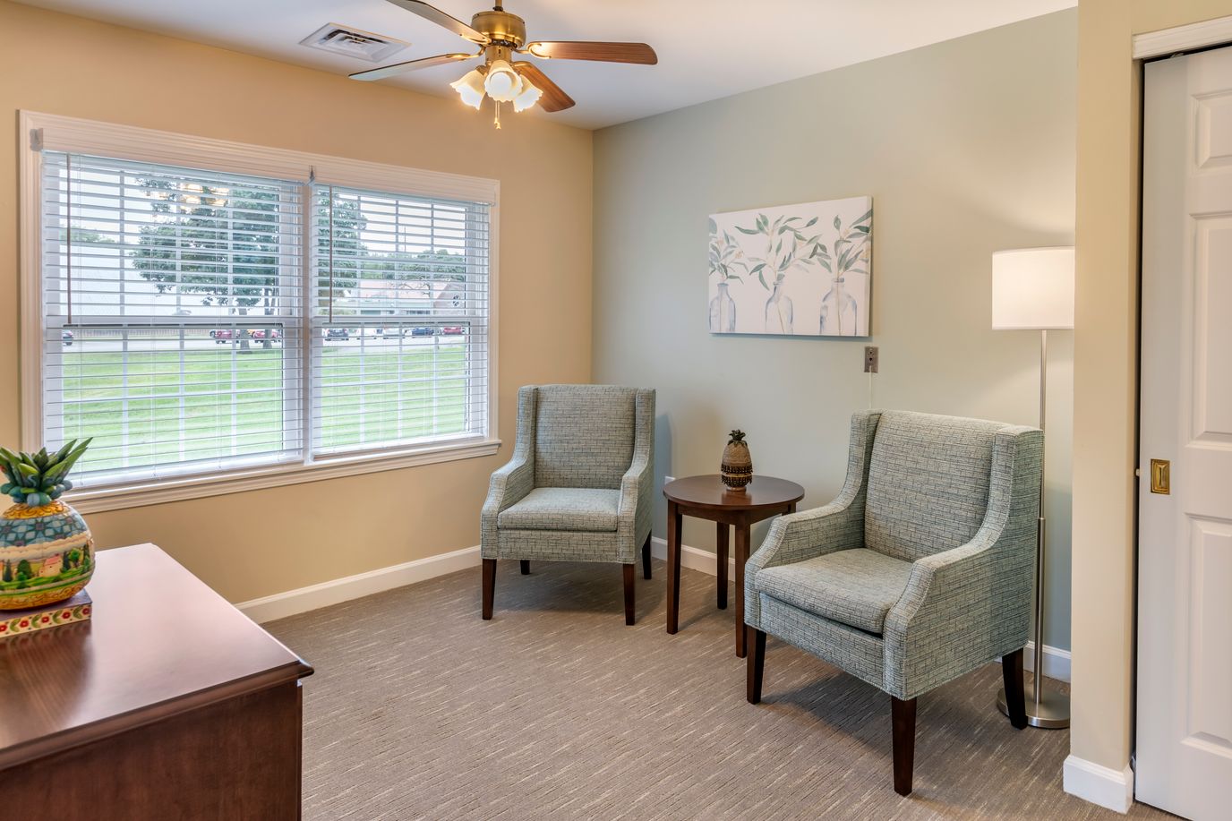 Cozy sitting area with two chairs and a side table.