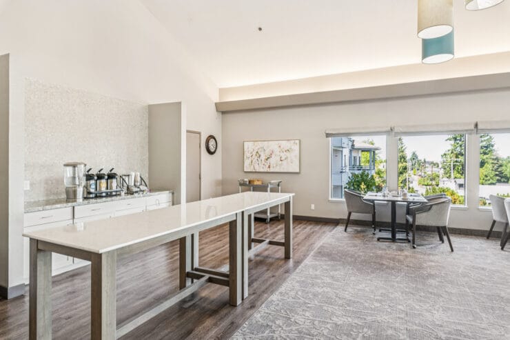 Bright common area with seating and view of outdoors.