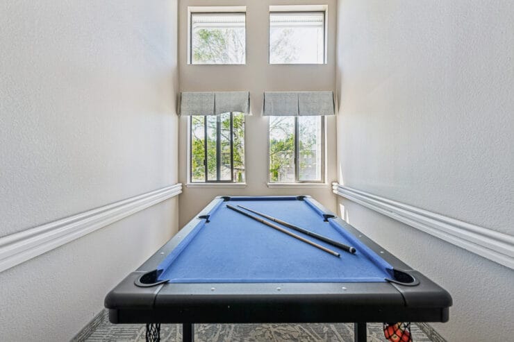 Billiards table with natural light by windows