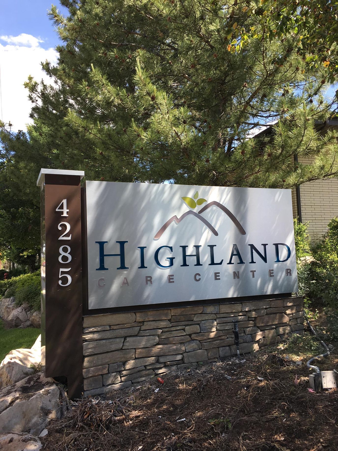 Signage for Highland Care Center with landscaping