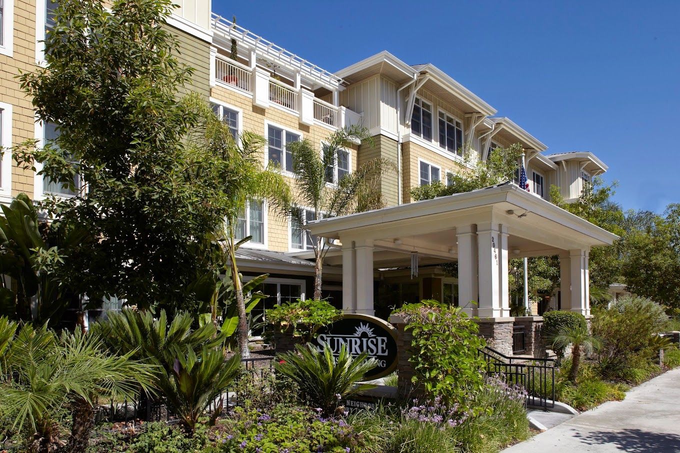 Front entrance of a senior living facility with landscaping