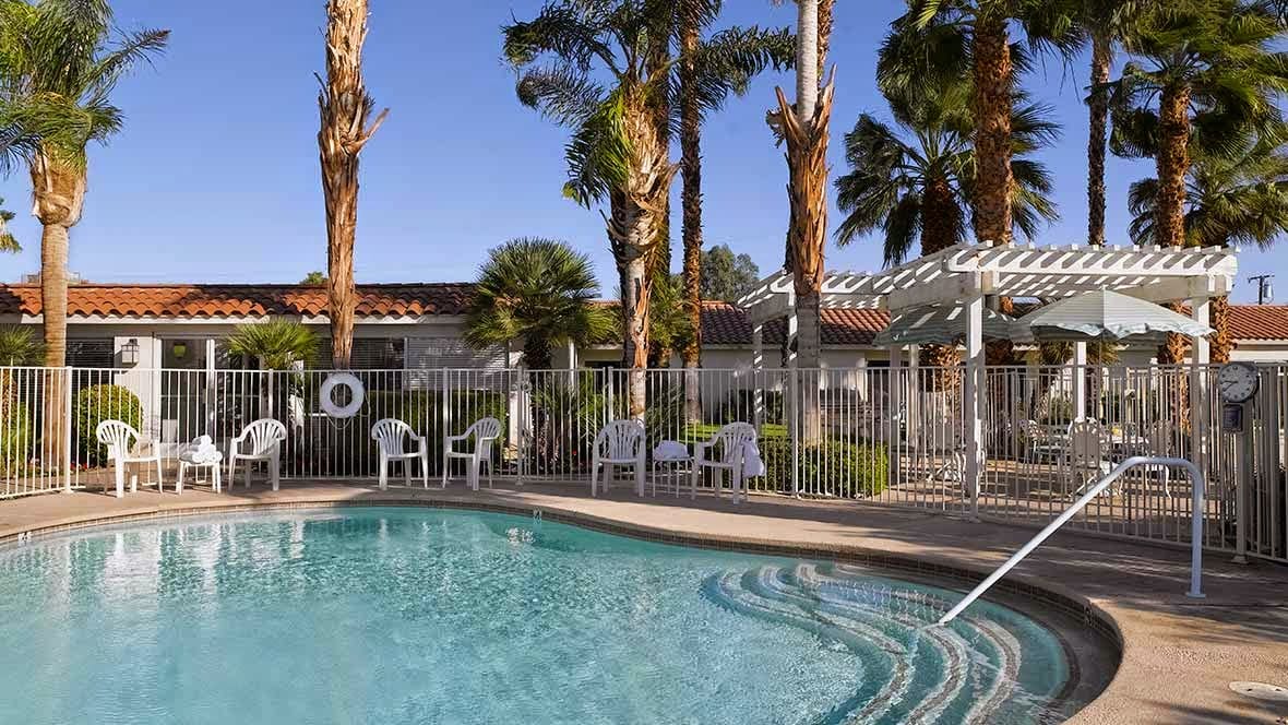 A serene pool area surrounded by palm trees