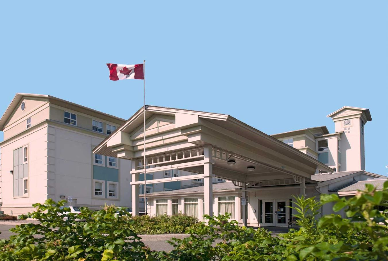 Exterior view of a senior living facility with Canadian flag