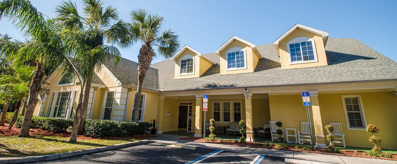 Exterior view of Brookdale DeLand with palm trees