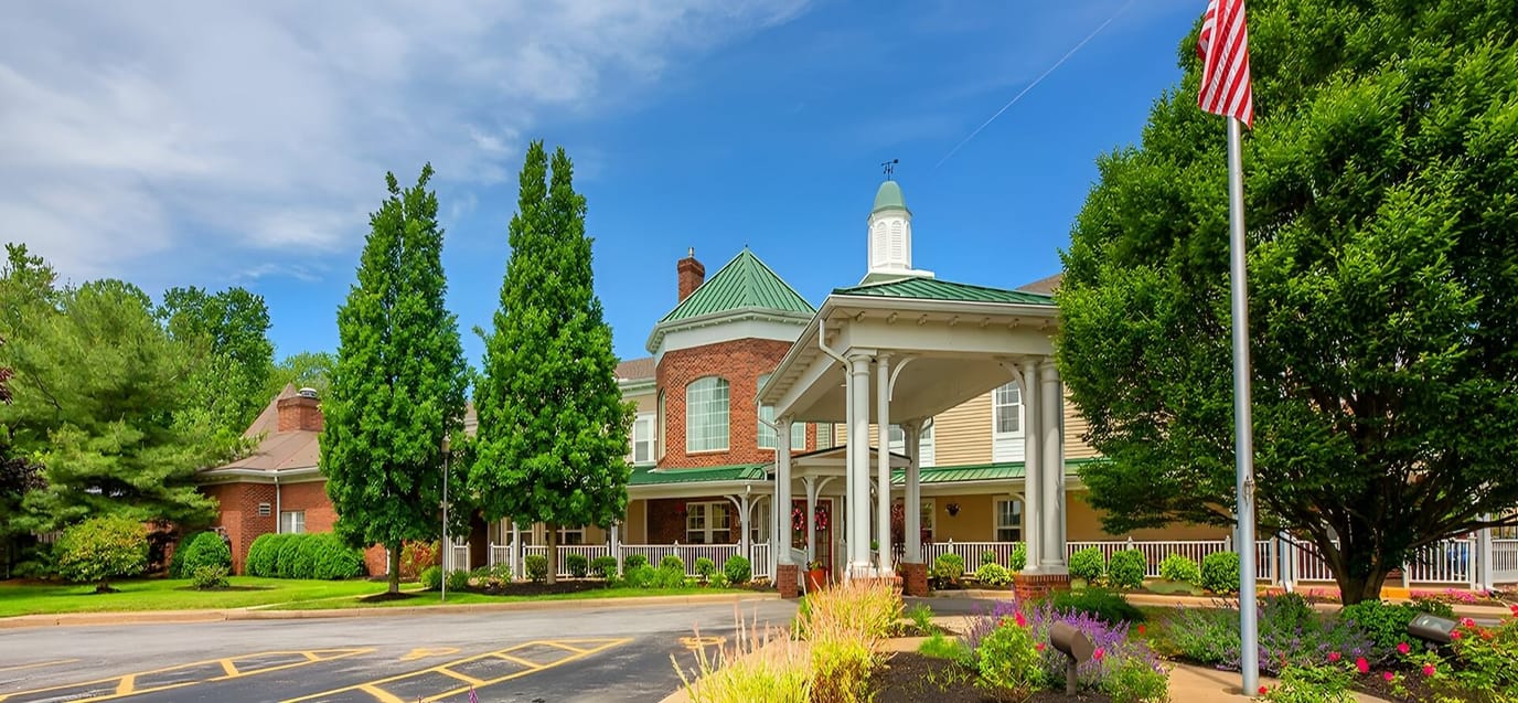Front view of a senior living facility with landscaping