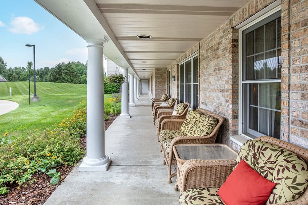 Outdoor seating area with wicker chairs on the veranda