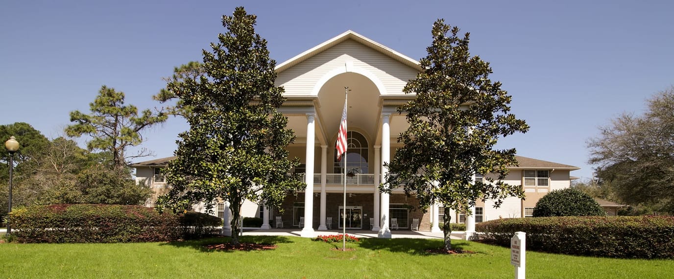 Exterior view of Brookdale St. Augustine surrounded by greenery