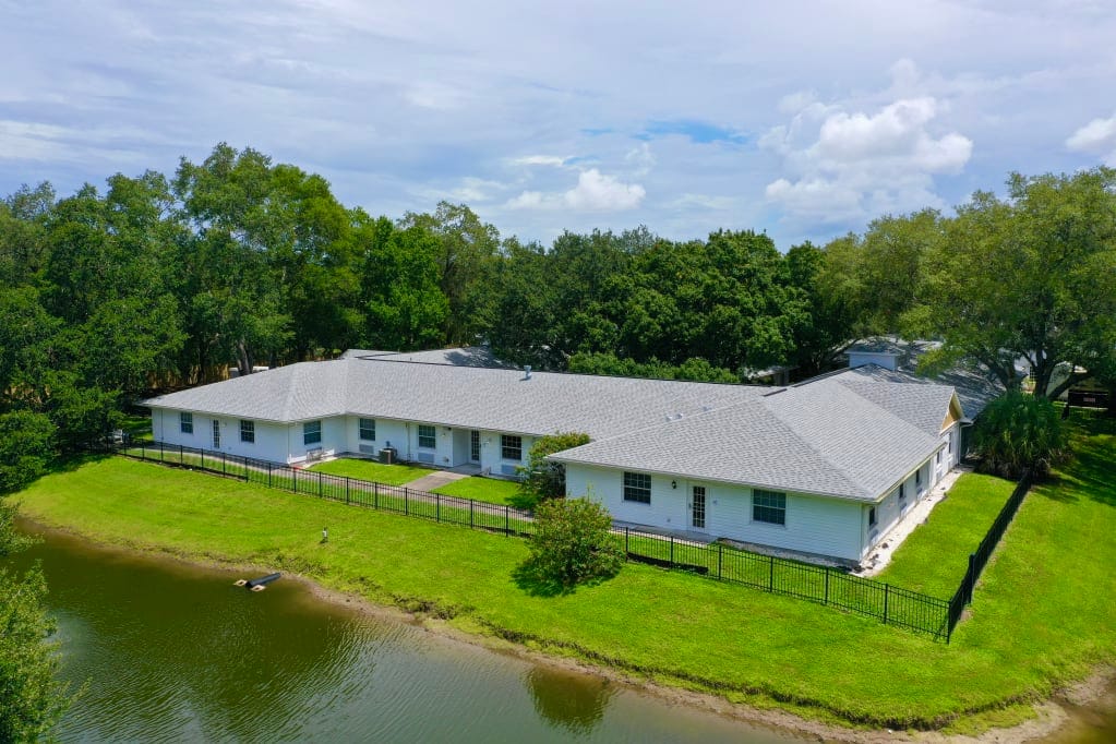 Aerial view of the facility's exterior near a pond