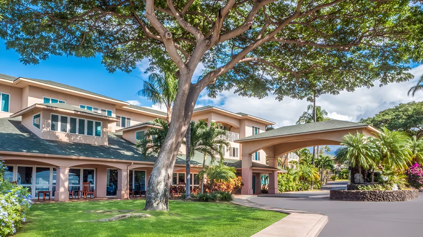 Exterior view of a senior living facility with trees