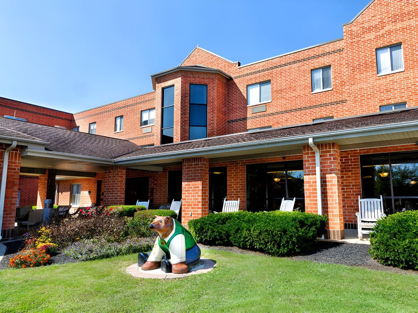 Exterior view of the facility with a garden and statue