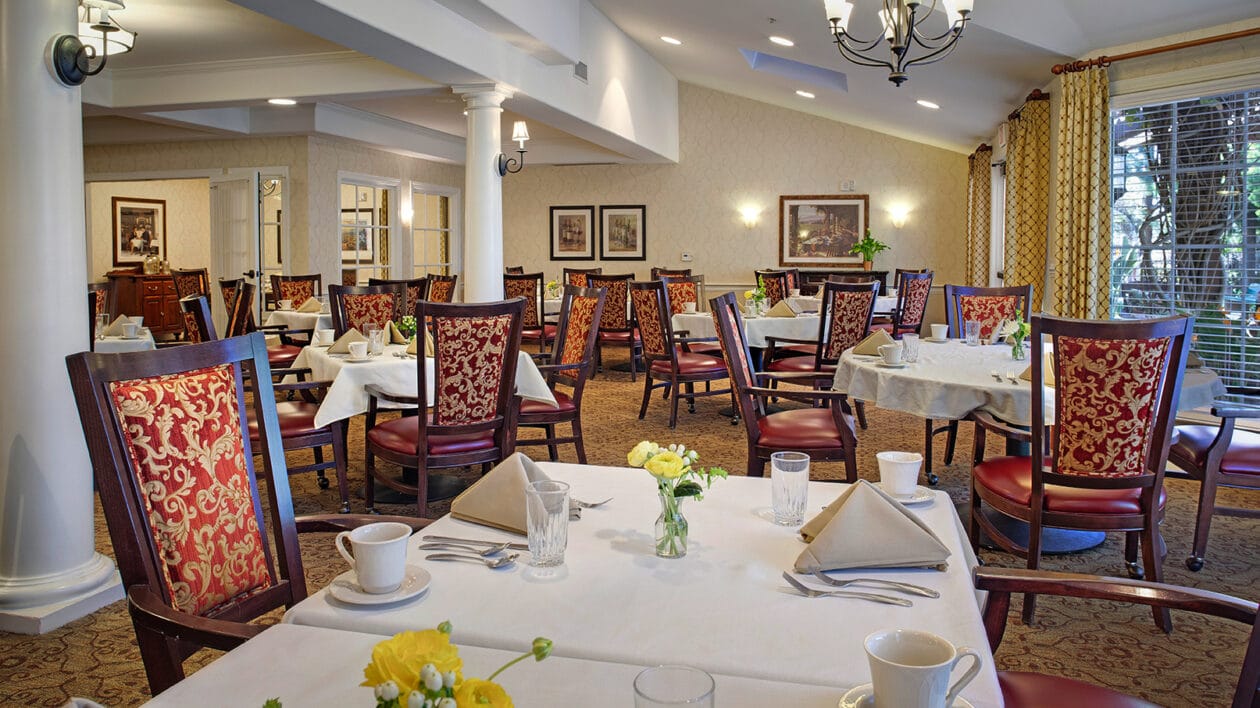 Dining area with elegantly set tables and chairs