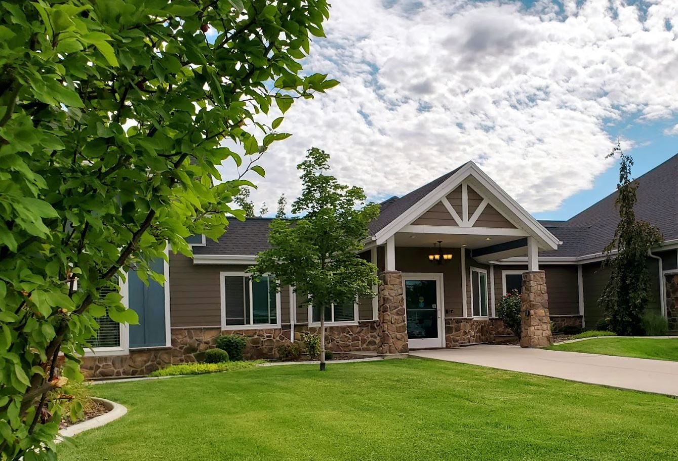 Exterior view of Lotus Park Senior Living with green lawn