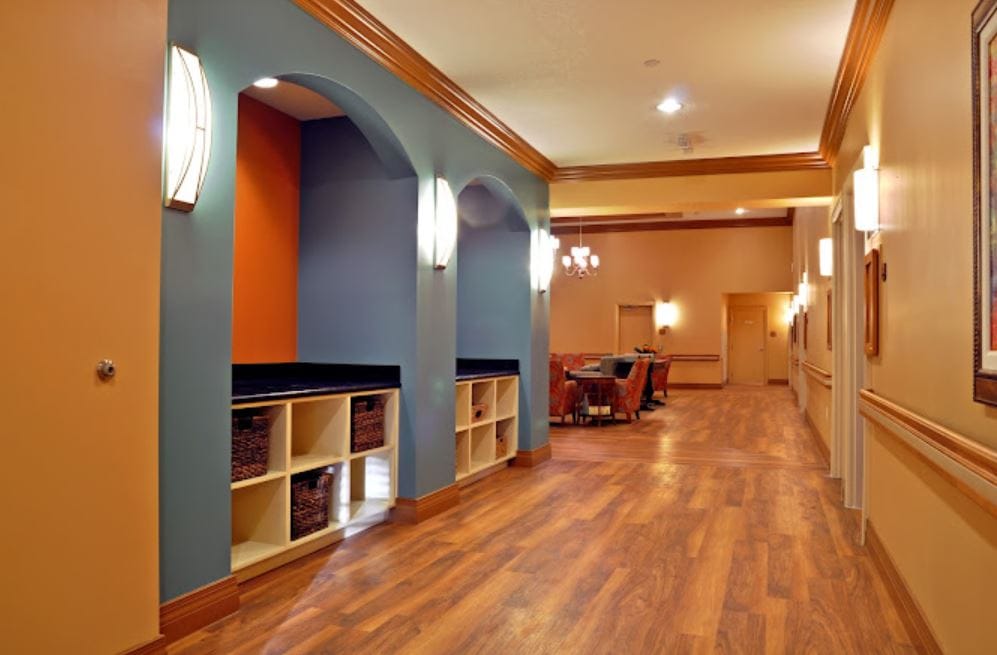 Interior hallway with decorative lighting and a seating area