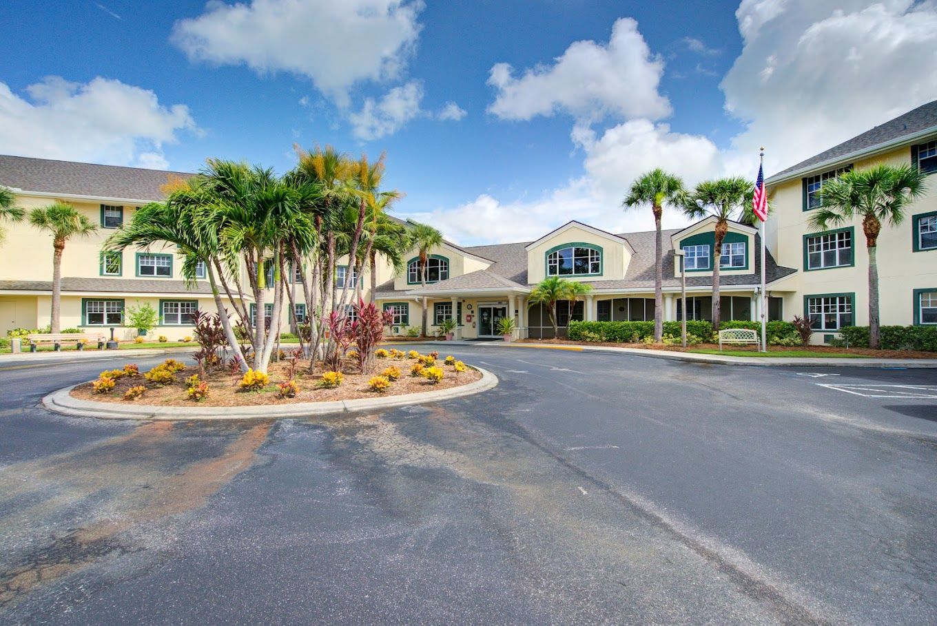 Exterior view of a senior living facility with landscaped entrance