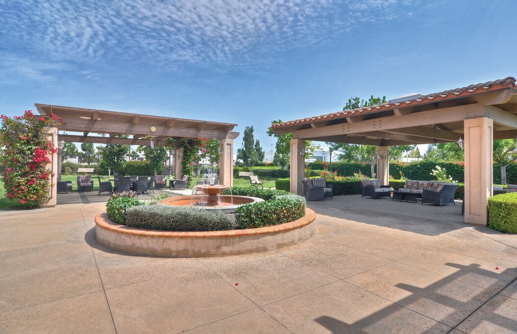 Relaxing outdoor lounge with a fountain and seating areas