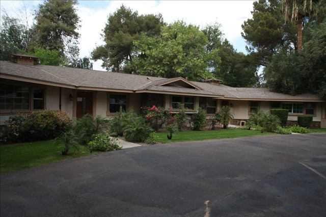 Exterior view of a senior living facility with gardens