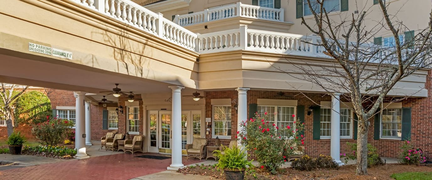 Entrance of a senior living facility with outdoor seating