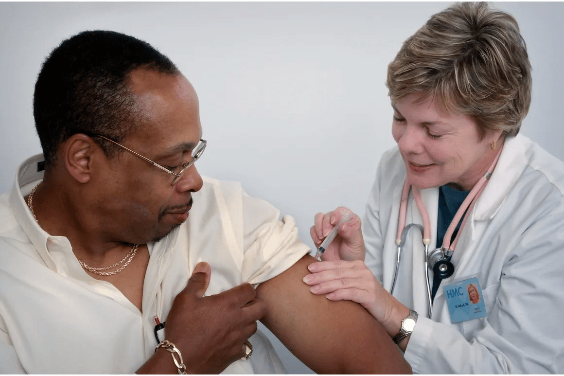 A healthcare provider administering a vaccine to a patient