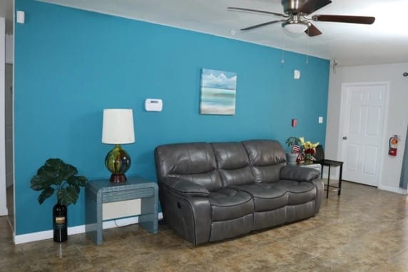 Ohana Senior Living, retirement home in Las Vegas, NV — Living room with teal walls and leather sofa