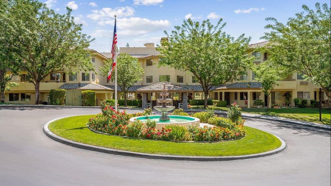 View of the facility's exterior with landscaping and fountain