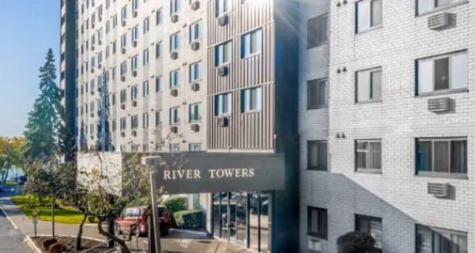 Exterior view of River Towers facility with entrance signage