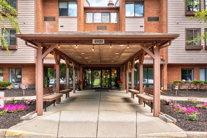 Entrance of a senior living facility with flowers