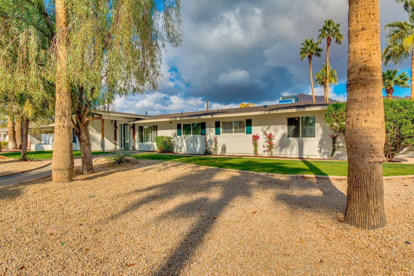 Exterior view of a senior living facility with palm trees
