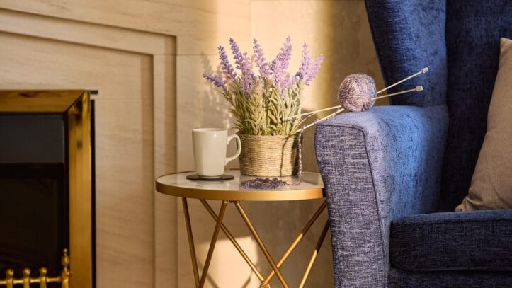 Hallmark Admiral Court, memory care — Cozy reading nook with a coffee cup and flowers