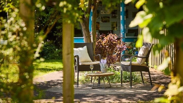 Hallmark Admiral Court, memory care — Outdoor garden seating area with chairs and table