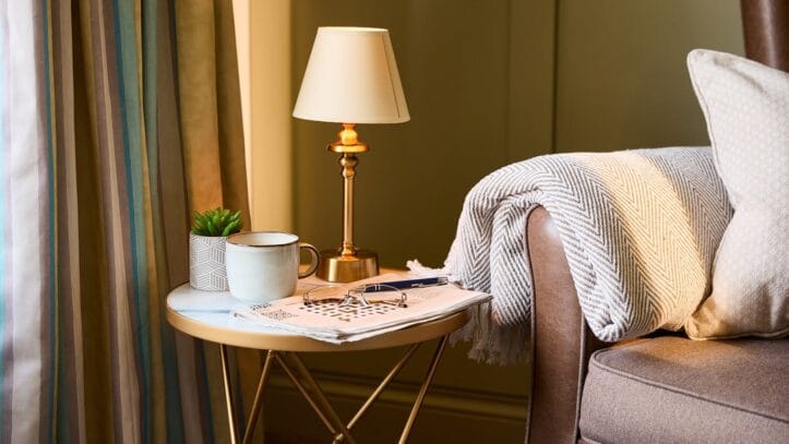 Hallmark Admiral Court, memory care — Cozy sitting area with lamp and decorative elements