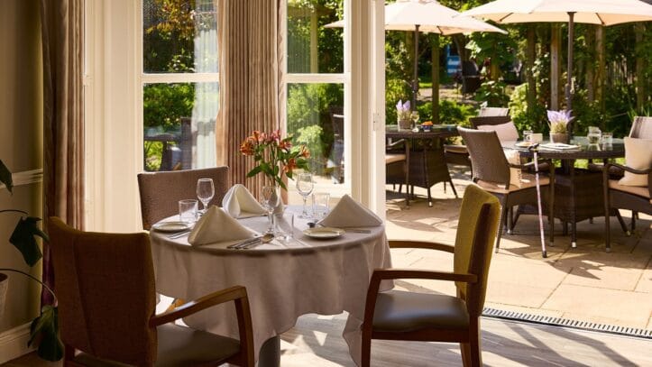 Hallmark Admiral Court, memory care — Elegant dining area with outdoor patio seating