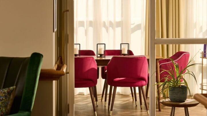Hallmark Admiral Court, memory care — Bright dining area with pink chairs and natural light