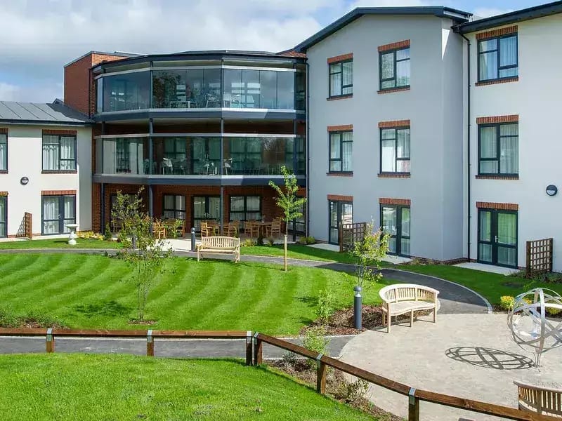 Chawley Grove, memory care — Courtyard of a senior living facility with landscaped gardens