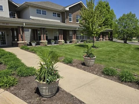 Exterior view of Charter Senior Living with landscaped area