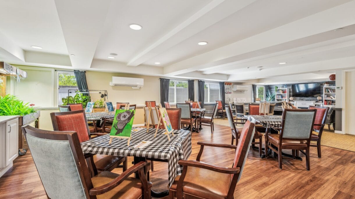 Bright, inviting common area with tables and art displays