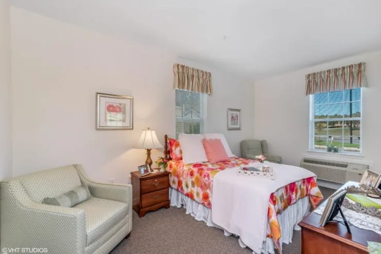 Cozy resident room with floral bedding and furniture