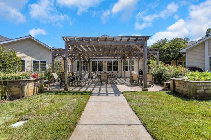 Outdoor patio area with seating and garden beds