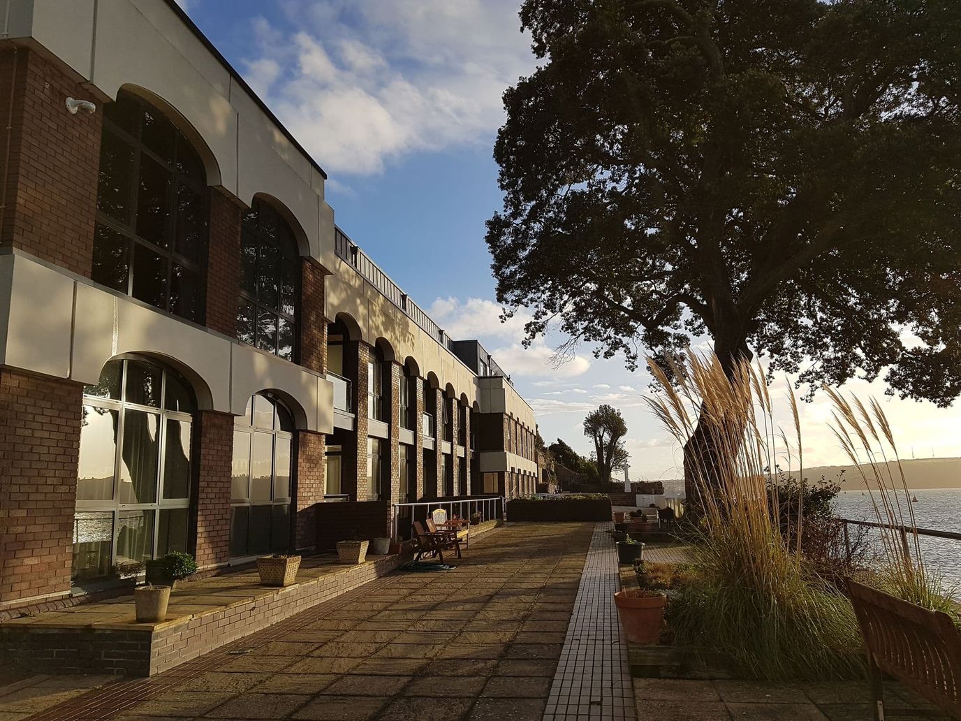 Exterior view of a senior living facility by the water