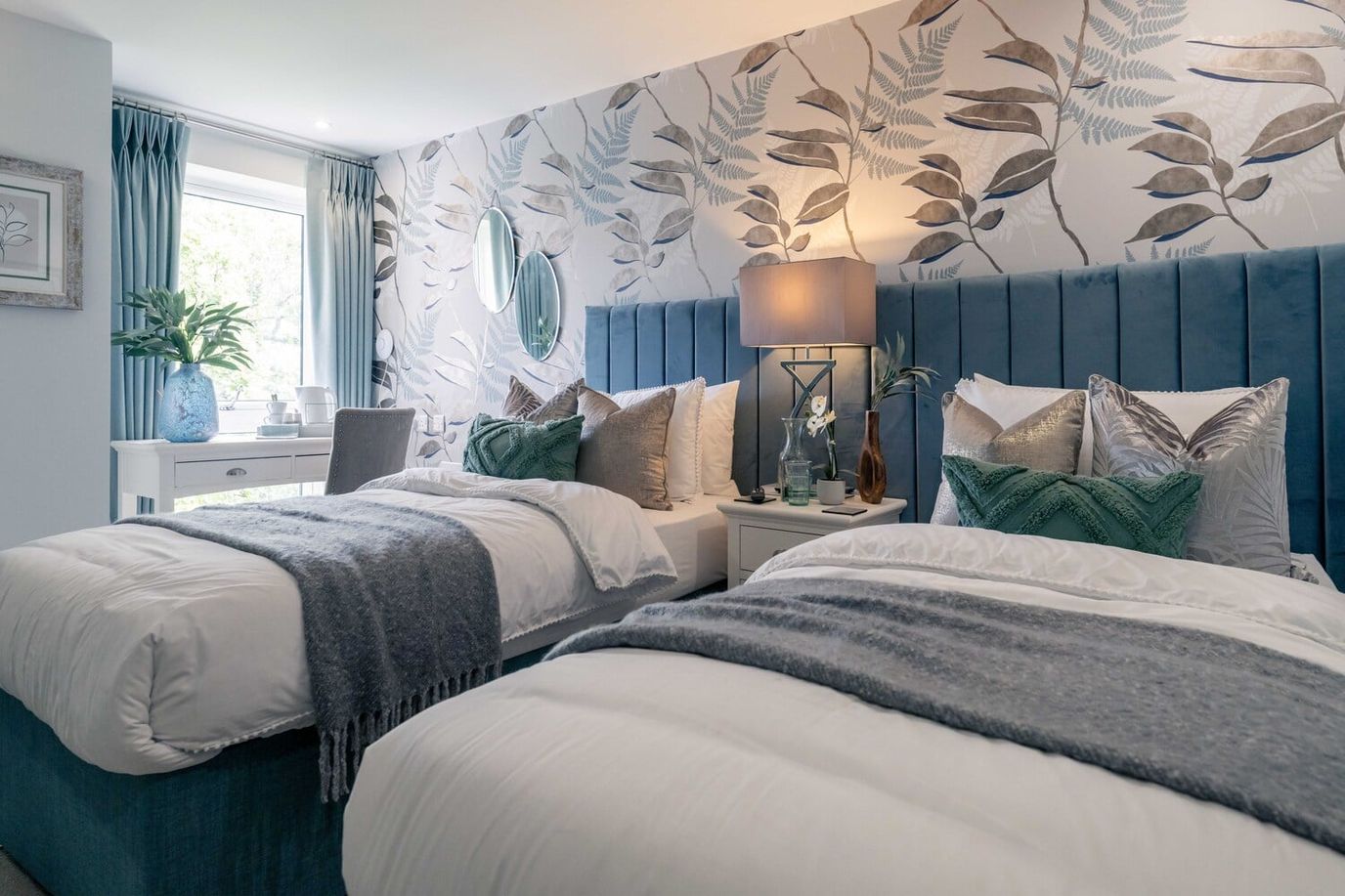 A beautifully decorated twin bedroom in a senior living facility